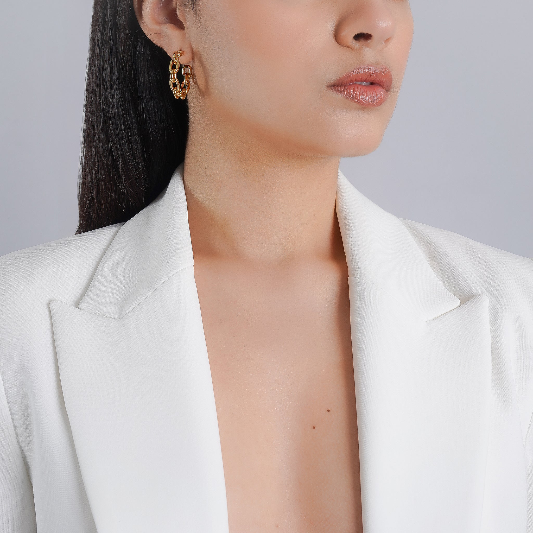 A pair of 18K gold-plated hoop earrings featuring bold chain links, designed to add modern charm to any outfit.