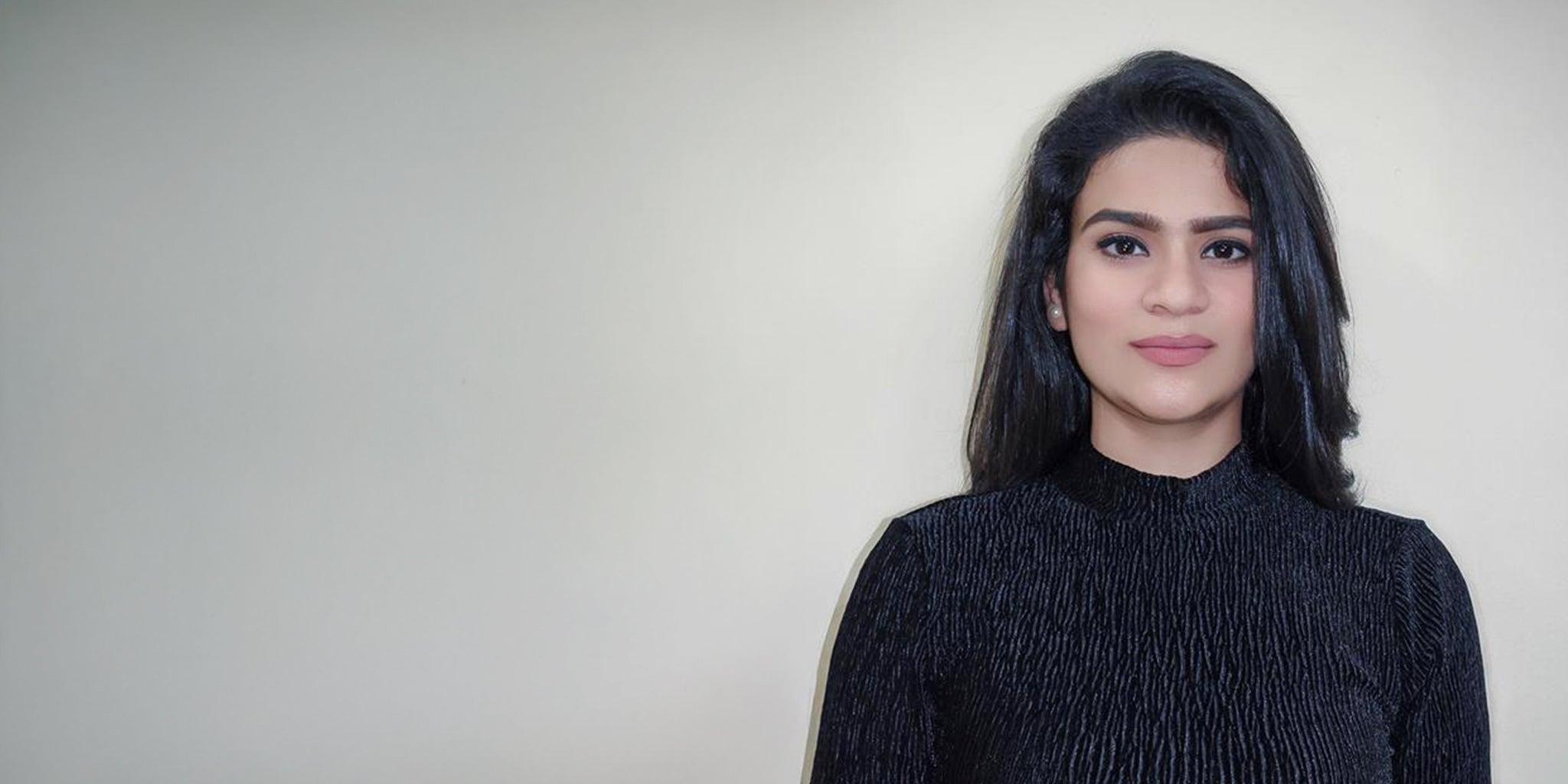 Founder of Embrell, Priyanka Silotia, wearing a black textured top against a soft beige background