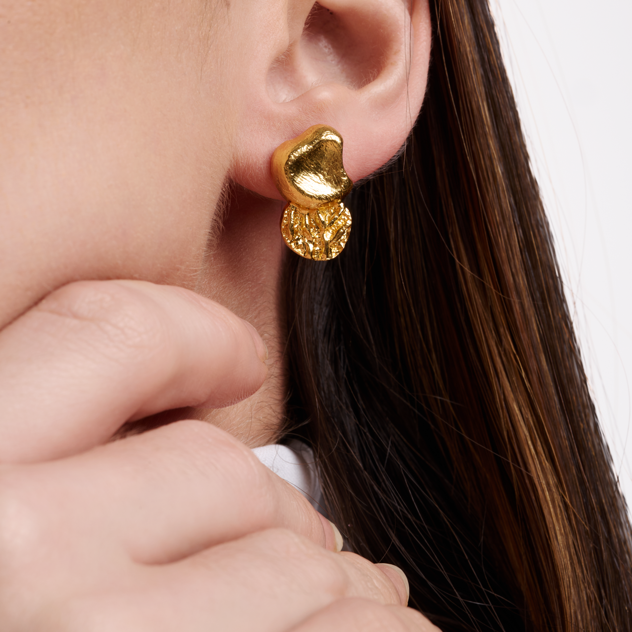 Embrell Becoming Balance Stud Earrings in 22K gold-plated finish, handcrafted molten textured design, demi-fine jewellery worn by a woman for a modern elegant look.