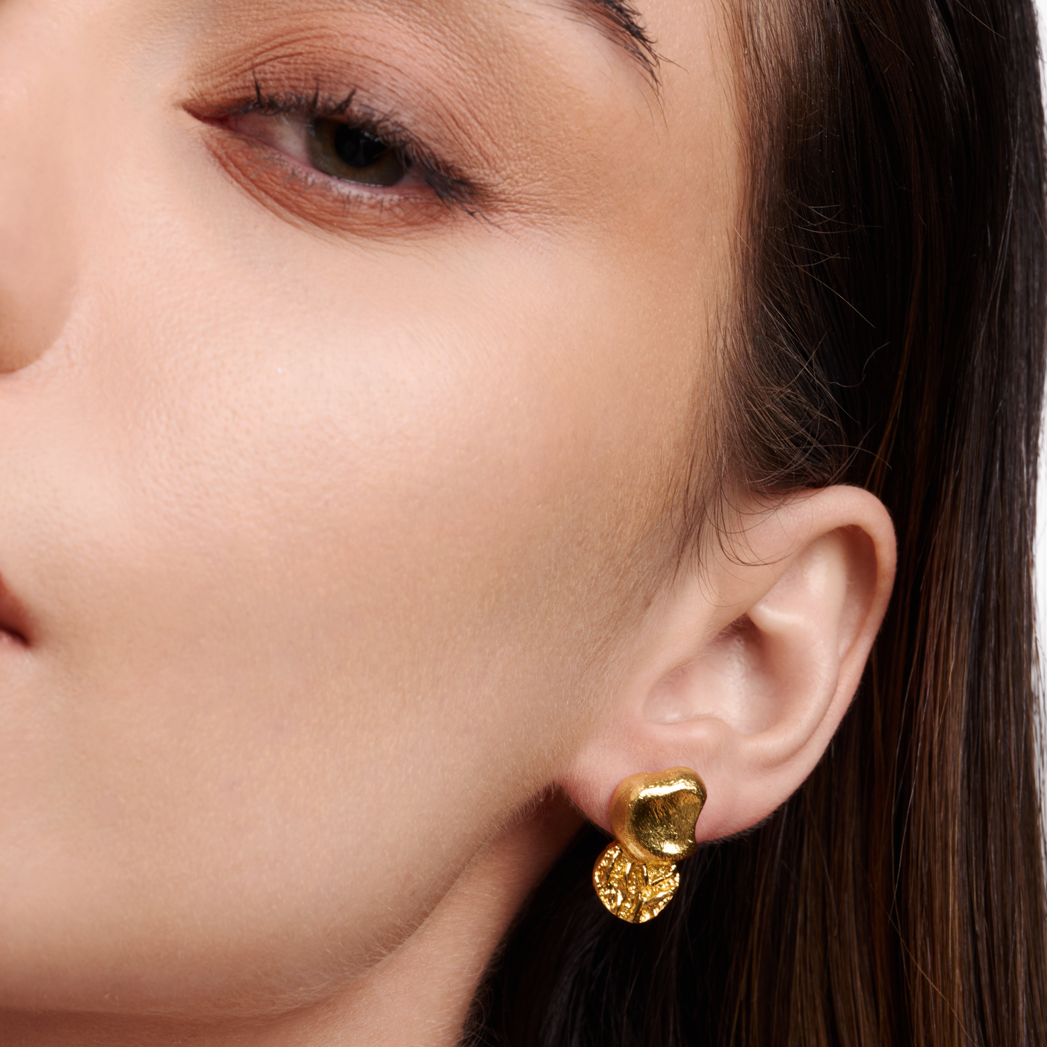Embrell Becoming Balance Stud Earrings in 22K gold-plated finish, handcrafted molten textured design, demi-fine jewellery worn by a woman for a modern elegant look.