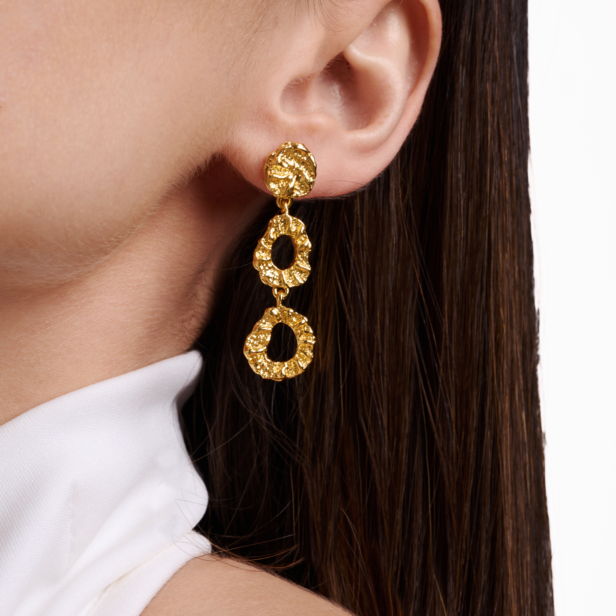 Embrell Becoming Evolve Earrings in 22K gold-plated finish, handcrafted molten textured triple drop earrings, demi-fine jewellery worn by a woman for a bold elegant look.