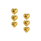 Gold heart-shaped earrings on a white background