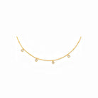 Gold necklace with small diamonds on a white background