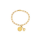 Gold bracelet with two charms on a white background