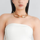 Model wearing an 18K gold-plated open choker necklace with elegant curves, adding a bold, minimalist touch to her look.