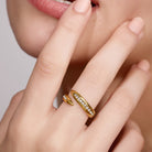Gold ring with small diamonds on a finger
