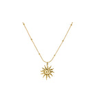 Gold necklace with a sun-shaped pendant on a white background
