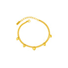 Gold bracelet with heart-shaped charms on a white background