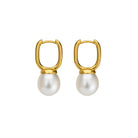 Gold hoop earrings with white pearls on a white background