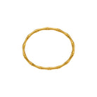 Gold bracelet with a bamboo design on a white background