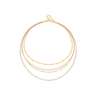 Four layer gold and silver necklace on a white background