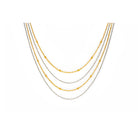 Four layer gold and silver necklace on a white background