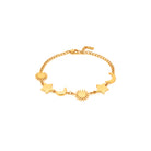 Gold bracelet with star, moon, and sun charms on a white background