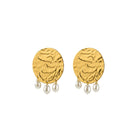 Gold earrings with pearl drops on a white background