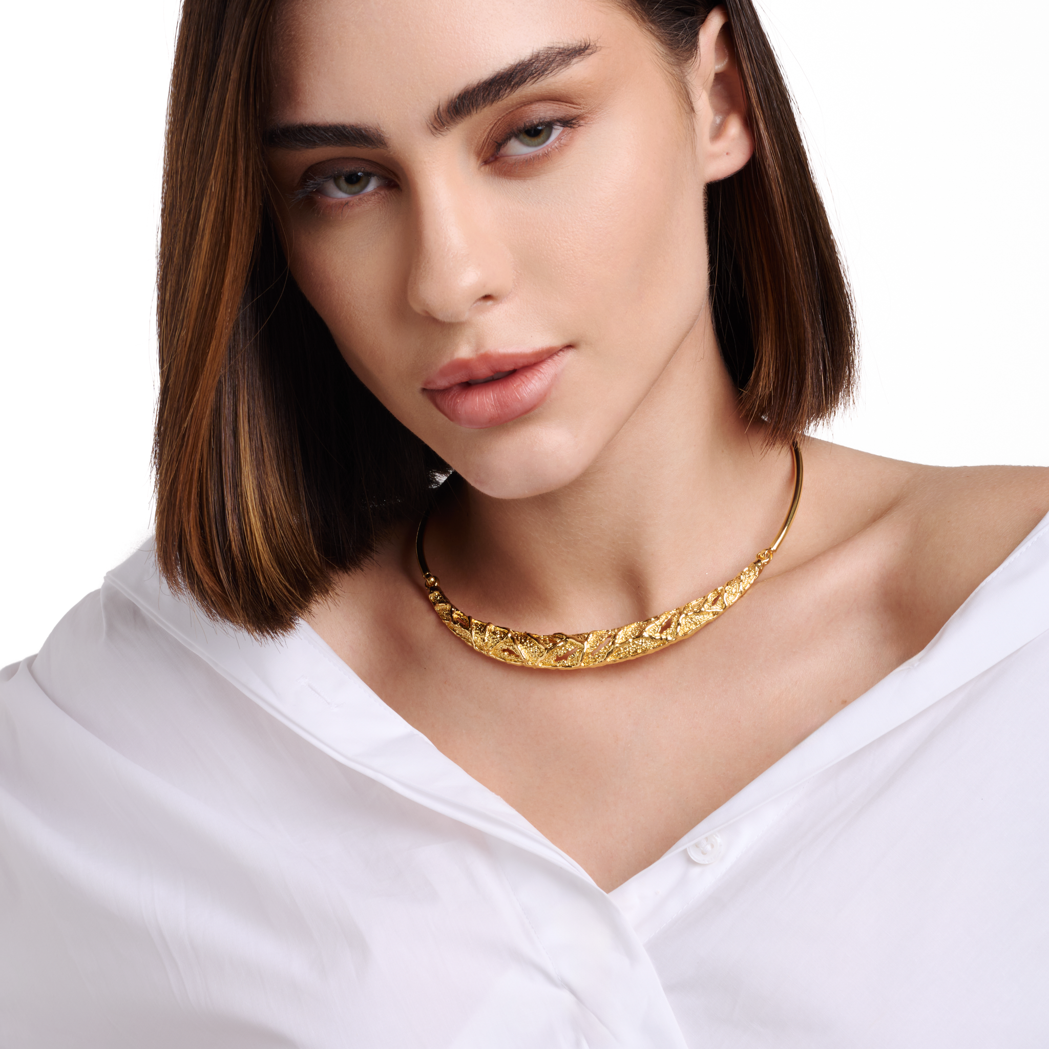 Embrell Becoming Fortune Necklace in 22K gold-plated finish, handcrafted molten textured choker-style necklace, demi-fine jewellery worn by a woman with a white shirt for a bold elegant look.