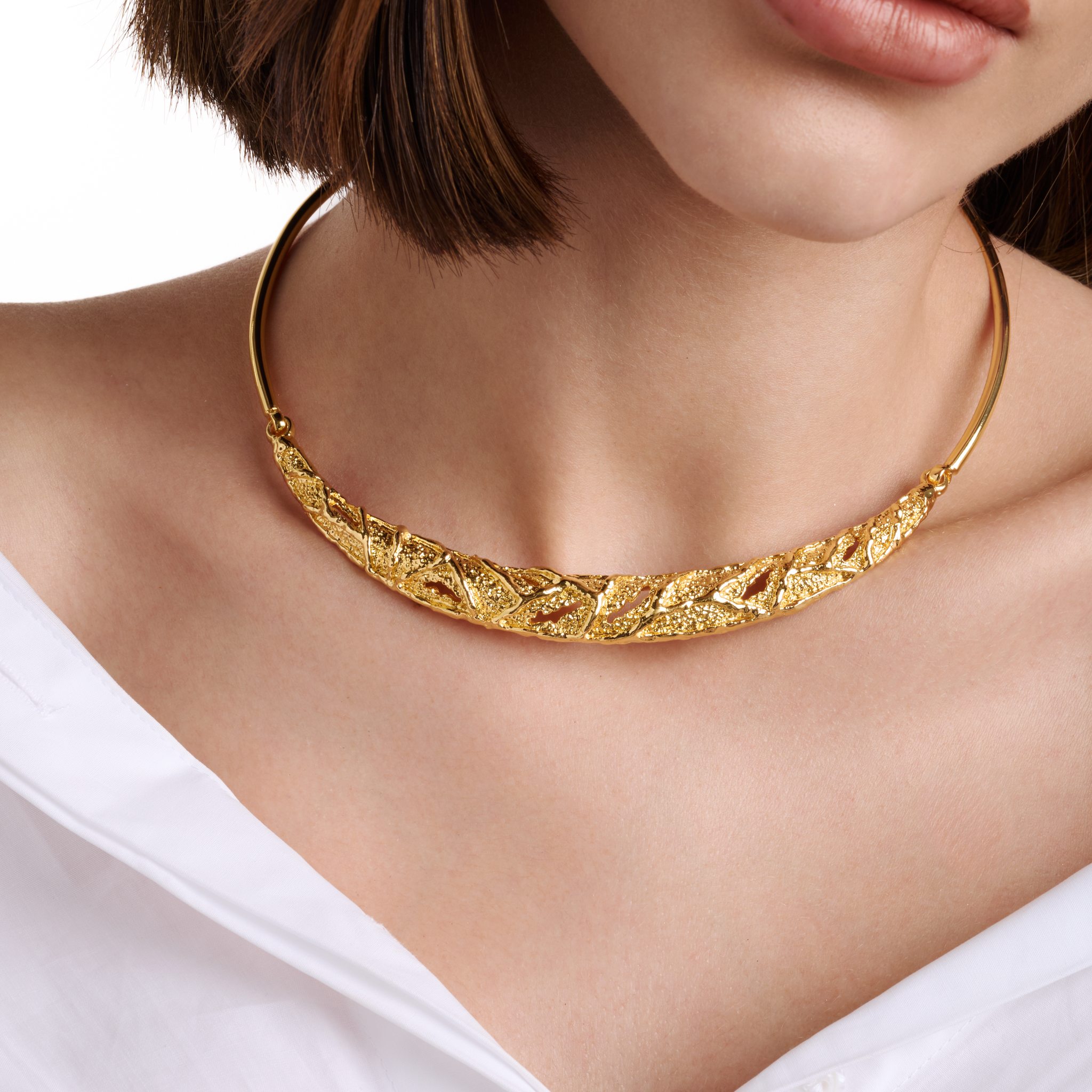 Embrell Becoming Fortune Necklace in 22K gold-plated finish, handcrafted molten textured choker-style necklace, demi-fine jewellery worn by a woman with a white shirt for a bold elegant look.