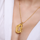 Embrell Becoming Lumen Pendant Necklace in 22K gold-plated finish, handcrafted molten textured open pendant on a fine chain, demi-fine jewellery styled with a white shirt for an elegant bold look.