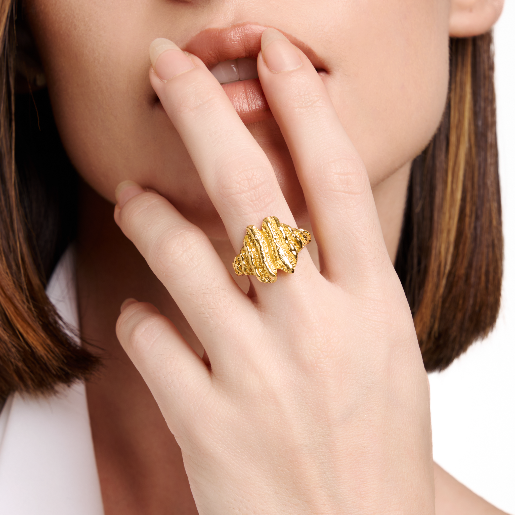 Embrell Becoming Summit Ring in 22K gold-plated finish, handcrafted molten textured statement ring with layered peak-like design, demi-fine jewellery worn by a woman for a bold elegant look.