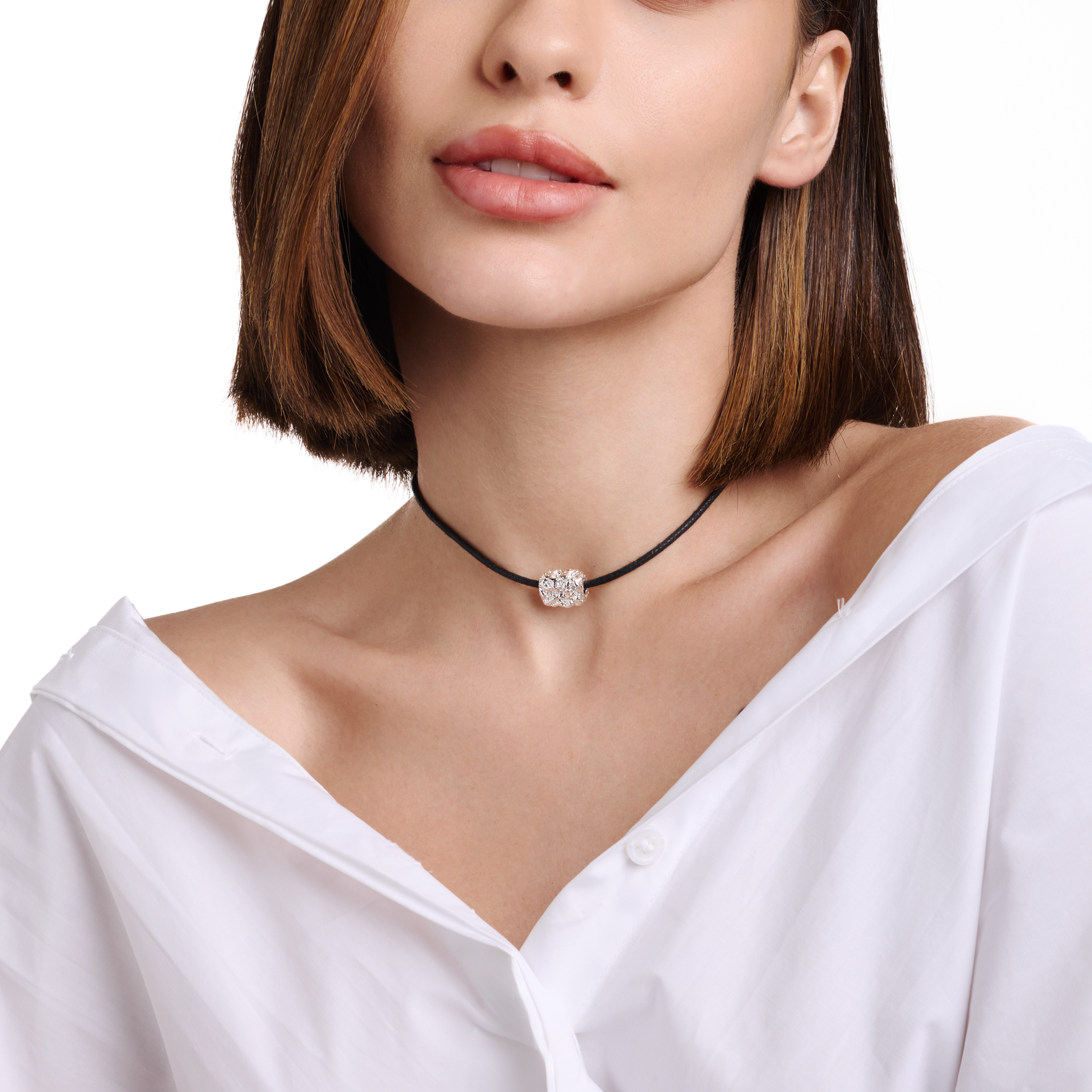 Embrell Becoming Talisman Necklace in silver rhodium-plated finish, handcrafted molten textured pendant on a black choker cord, demi-fine jewellery worn by a woman styled with a white shirt for a modern elegant look.